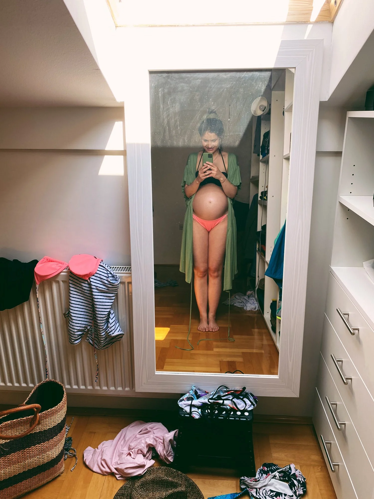A pregnant mom taking a mirror selfie